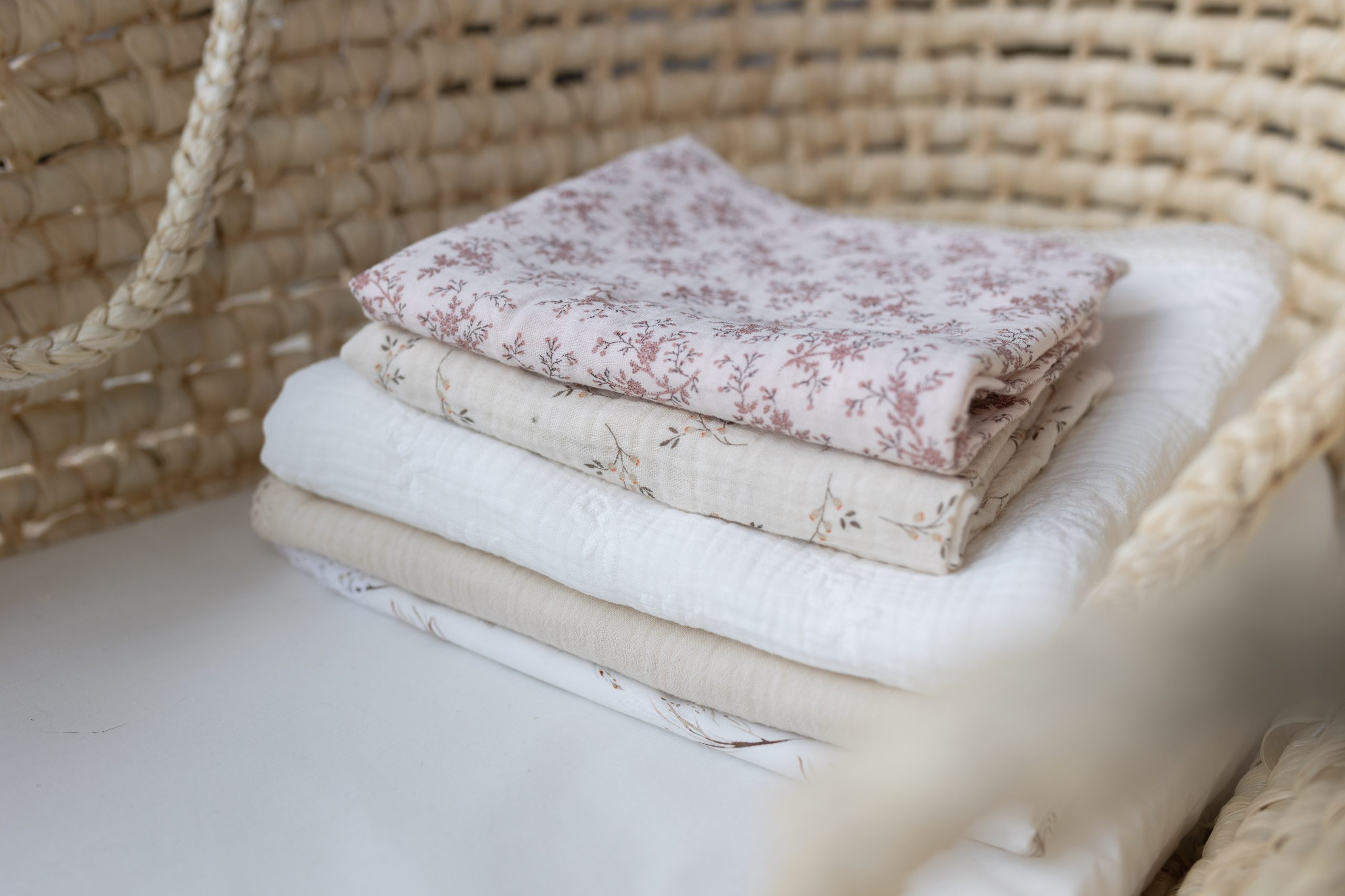 a stack of blankets on a chair